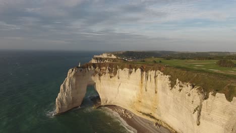 Aerial-drone-shot-over-white-cliffs-and-three-natural-rock-arches-of-Etretat.